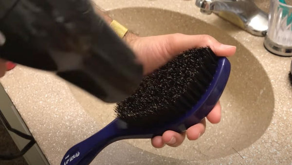 Use a blowdryer on the cool setting until bristles are dry
