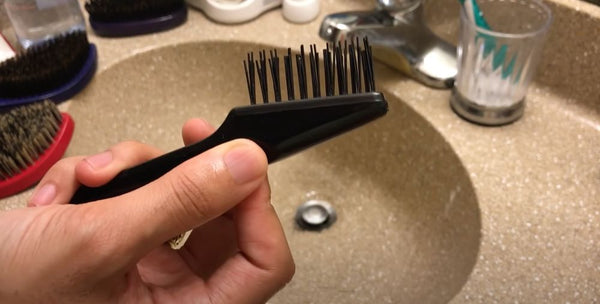 Use the hairbrush cleaner to remove as much hair