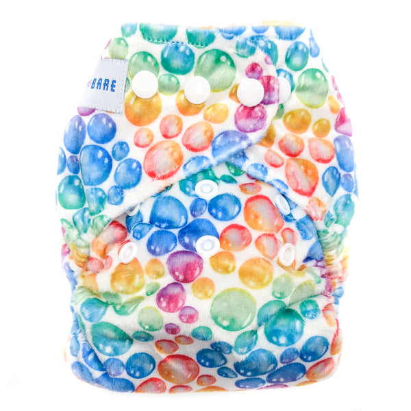 A cloth nappy in minky fabric with a colourful bubble print