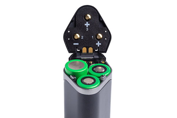 An upside-down vape is open, showing a battery compartment.