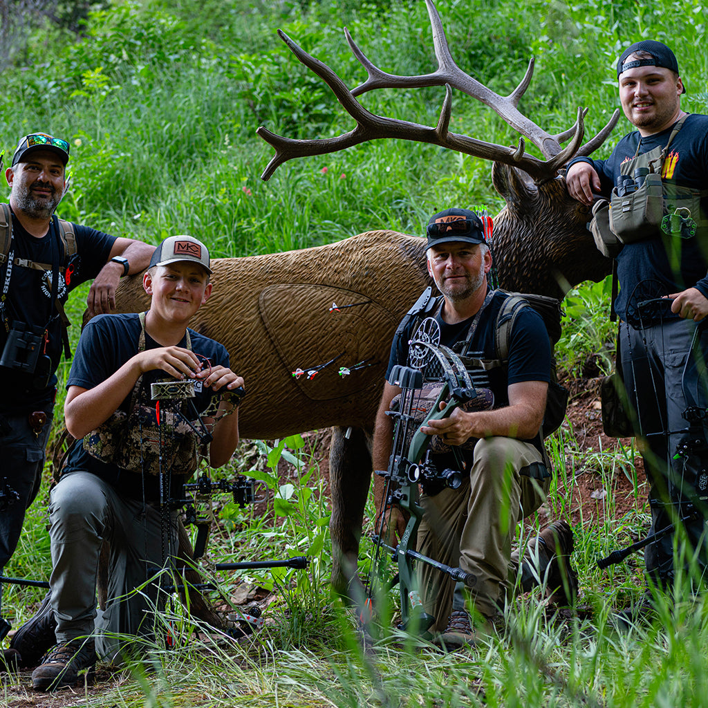Josh Smith of Montana Knife Company on a hunt with three friends, holds a deer. 