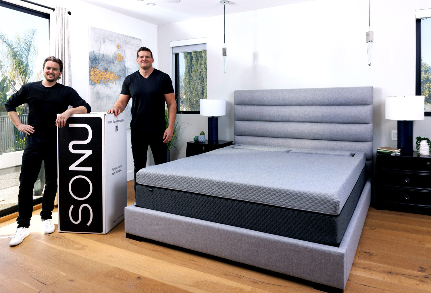 The SONU Sleep Company Founders, Stason Strong and Brad Hall, next to a king size SONU Sleep System mattress in a contemporary bedroom.