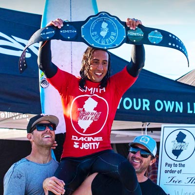 Photo of Pro Surfer Rob Kelly holding his prize trophy belt