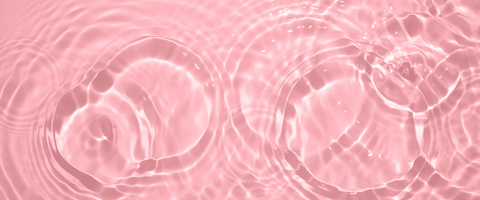 Water ripples against pink background