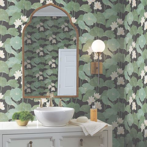 Black RoomMates Lily Pad Peel and Stick Wallpaper in a bathroom setting with a white vanity and a gold framed mirror.  