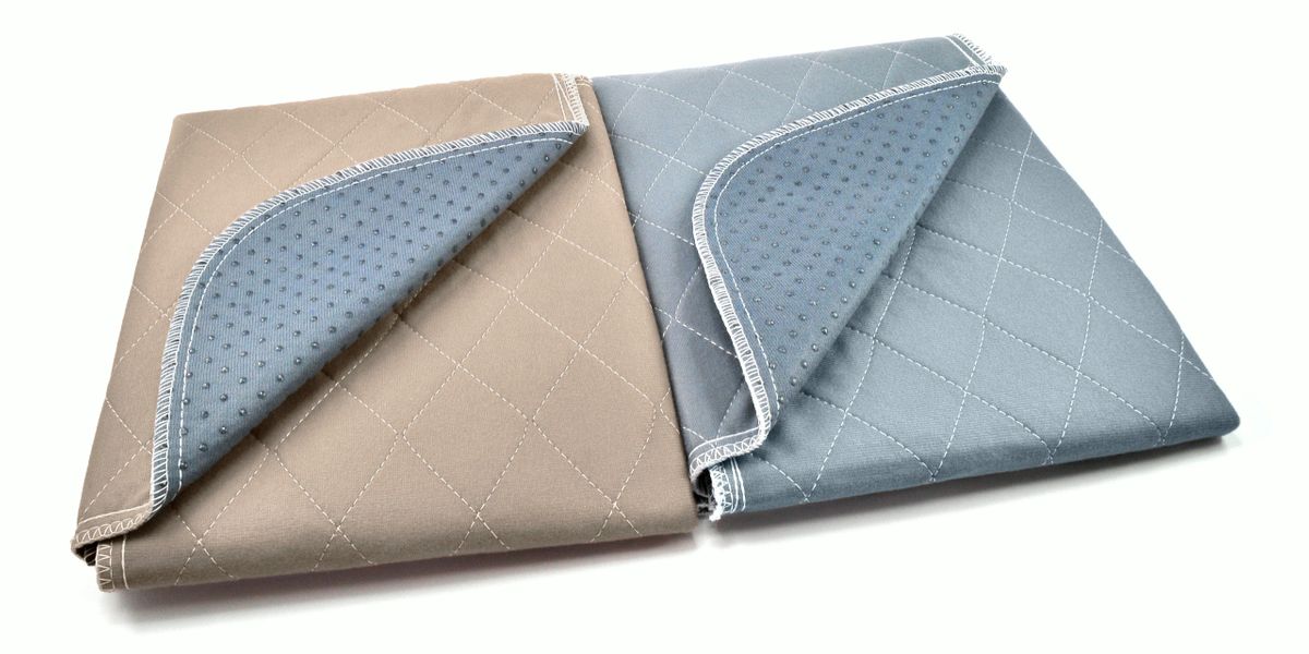 Two Pipco Pets pee mats side by side one grey one brown with corners folded down to show non-slip dots underneath