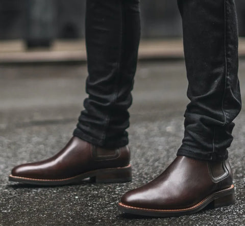 Chelsea boots styled with dark denim jeans