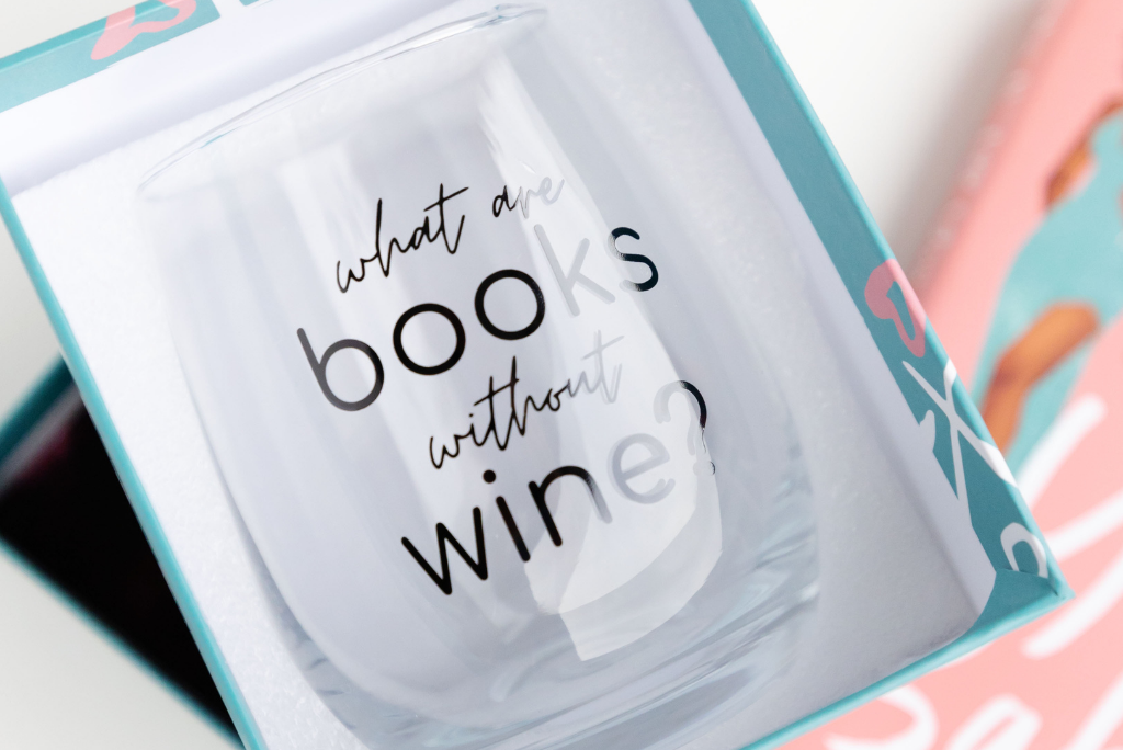 A wine glass with "what are books without wine?" printed on it.
