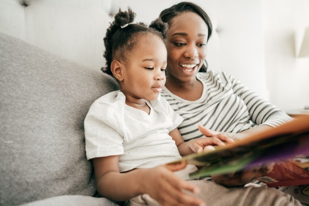 Mother and child bonding over a book, highlighting Once Upon a Book Club's focus on enhancing reading skills.