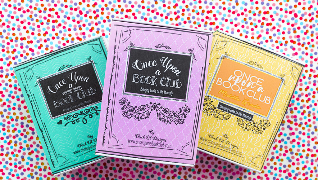 Colorful "Once Upon a Book Club" boxes in teal, purple, and yellow for the Young Adult and Middle Grade editions, arranged on a vibrant polka-dotted background, symbolizing a festive literary gift.