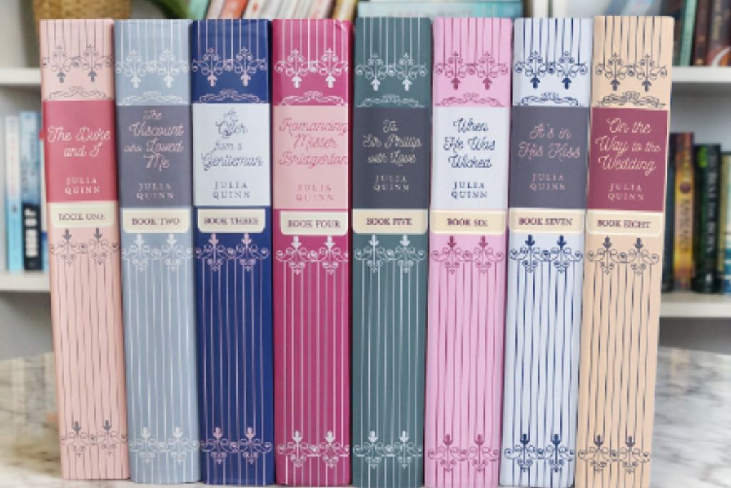 Row of Julia Quinn's romance novels from the Bridgerton series, arrayed in pastel hues, evoking love letters from literature.