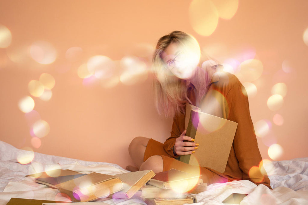 Woman with glasses reading amidst glowing lights and scattered books.