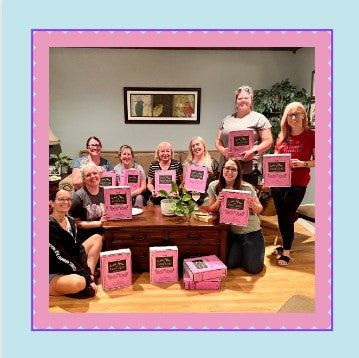 Women of different ages are holding the "Write Your Own Story" box by Once Upon a Book Club.