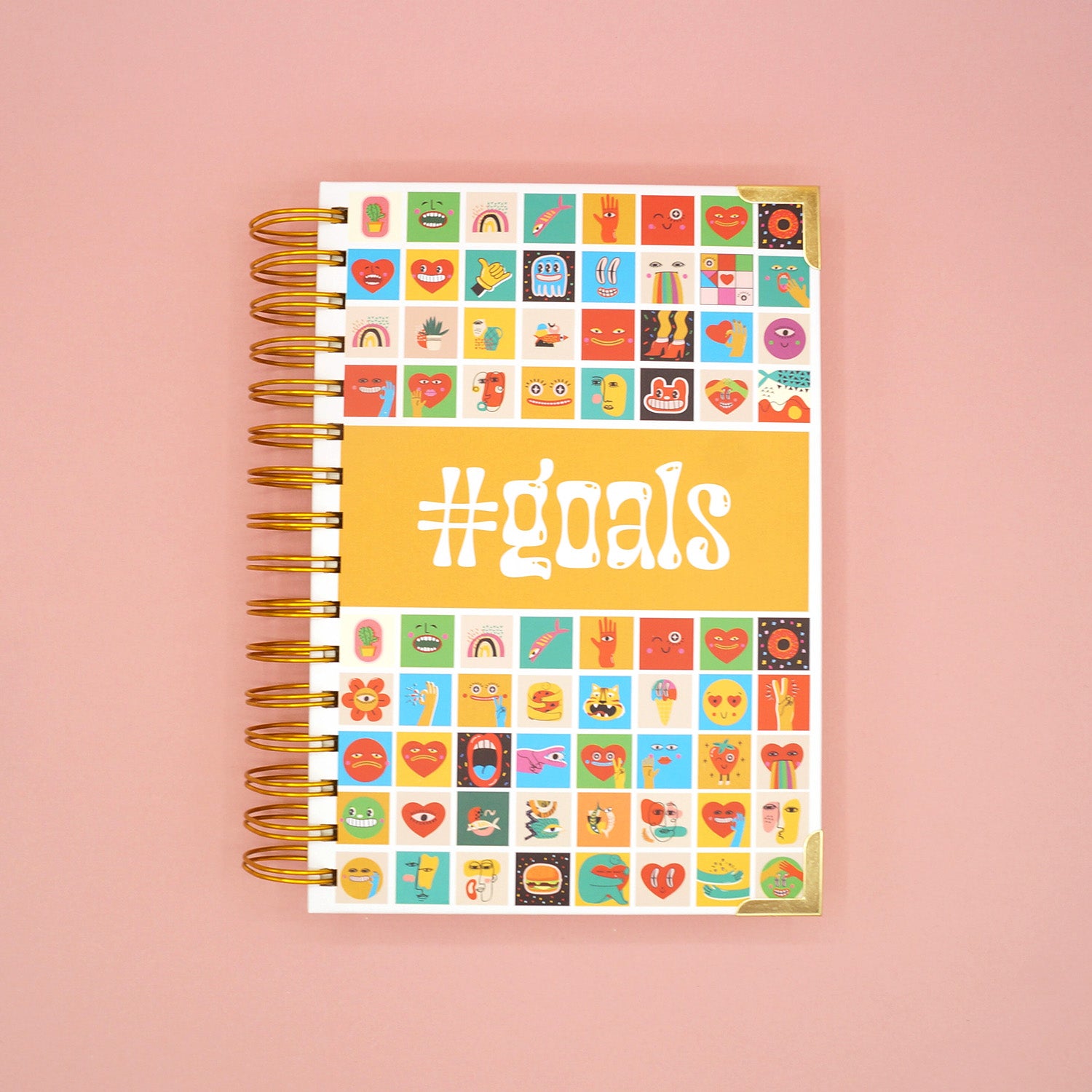 a notebook featuring #goals and emojis on the front cover