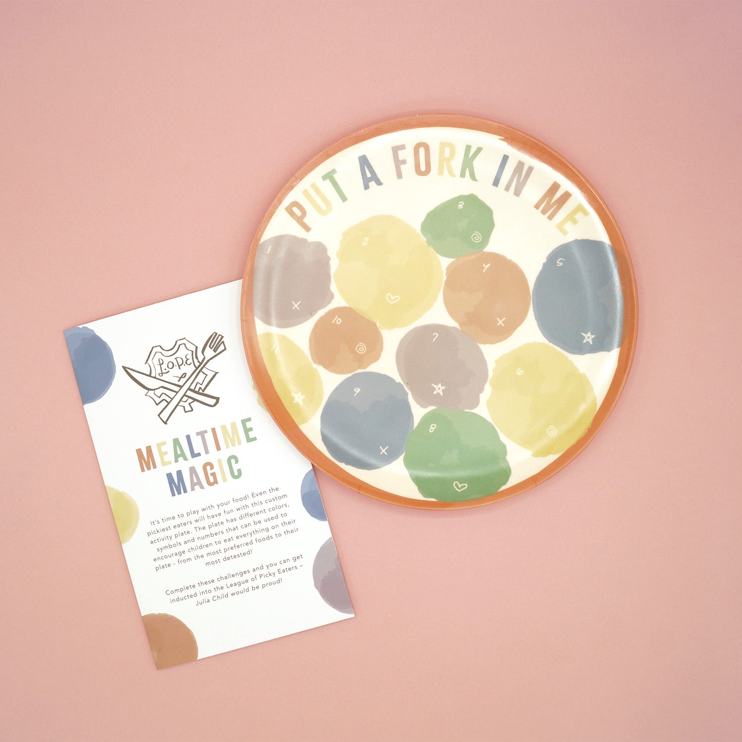 Set of 2 plates with multicolored blobs printed on them and text saying Put a Fork In Me.