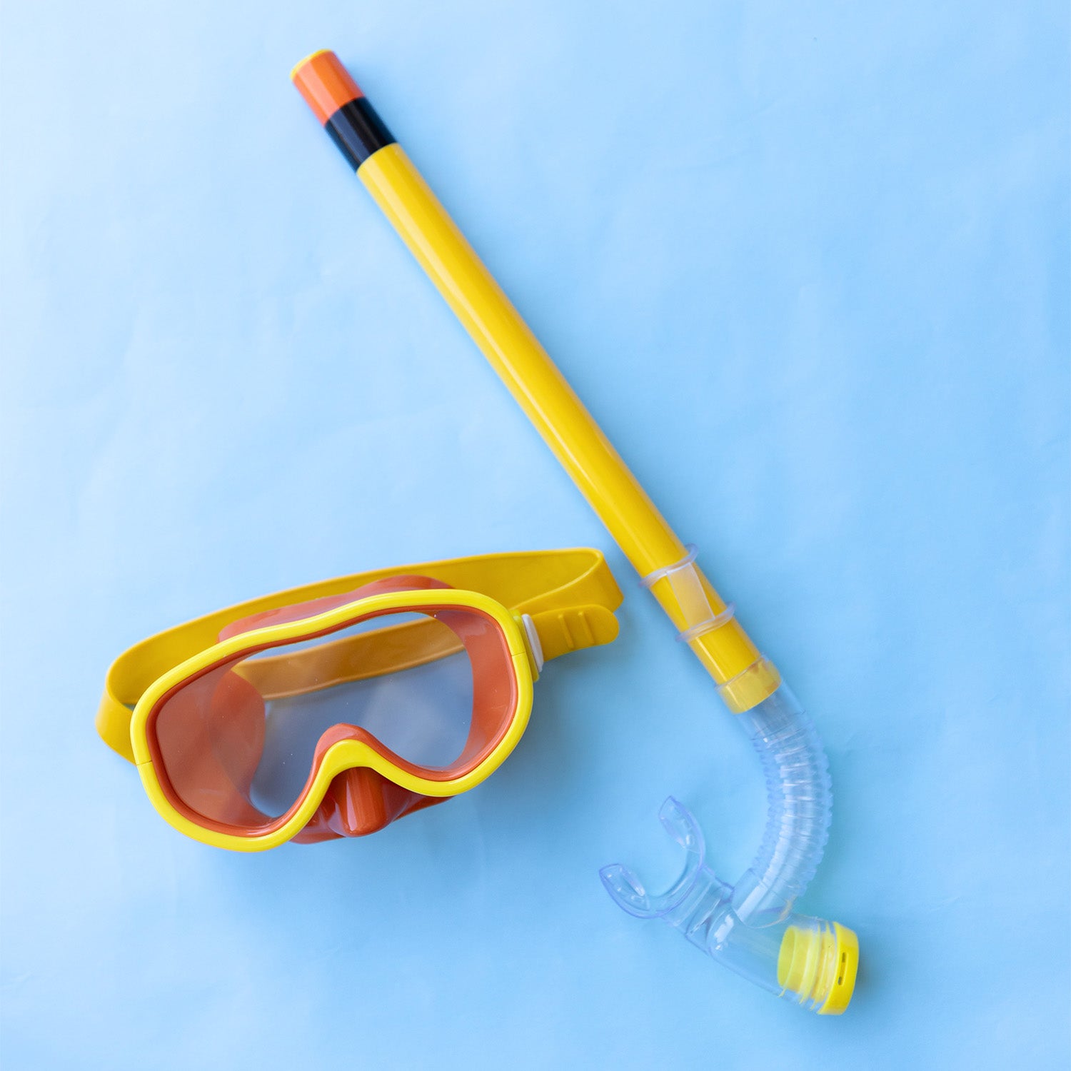 A yellow kids snorkel set including a mask, mouthpiece, and snorkel.