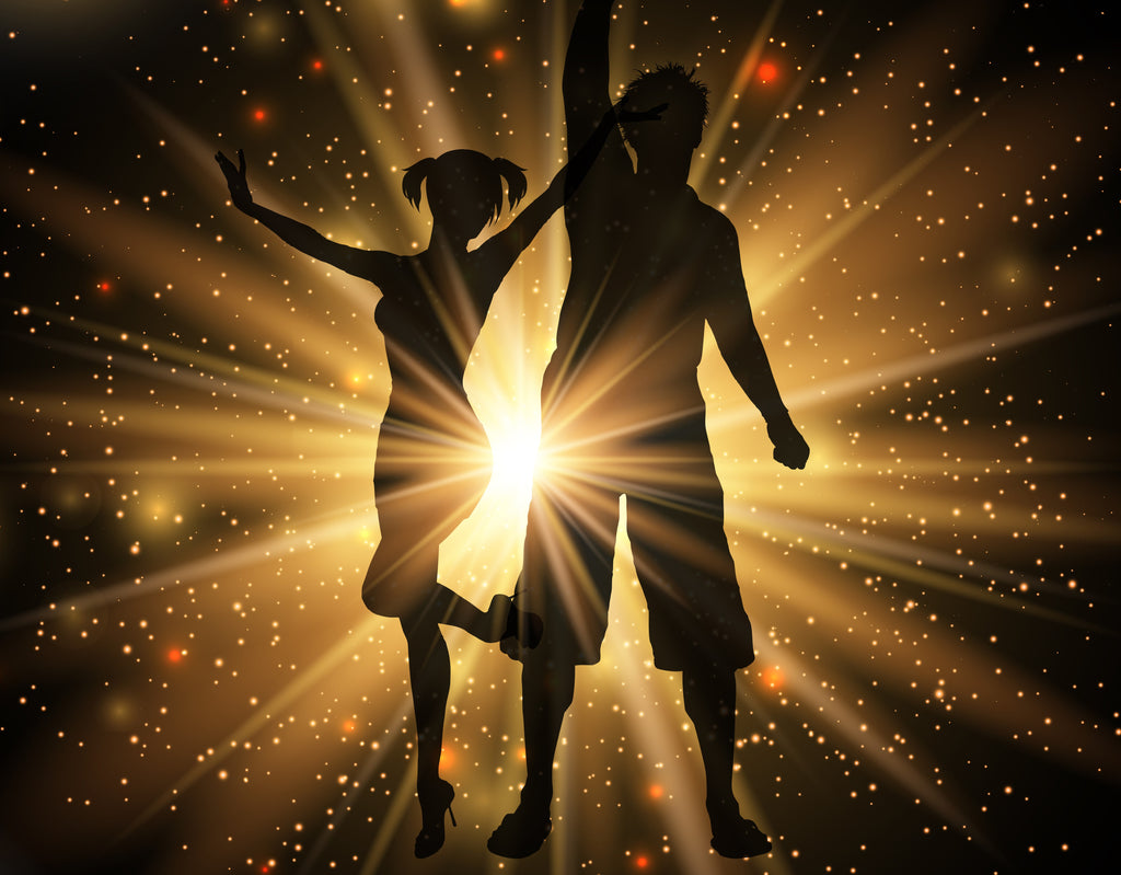 Silhouettes of a couple dancing joyfully with a magical sparkle background.
