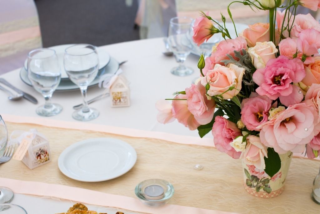 Elegant dining setup with pink roses, perfect for a Literary-Inspired evening.