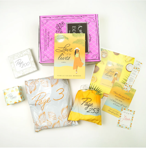 An open Once Upon a Book Club box with the book "Love Lives Here" by Tami Said Messe, surrounded by individually wrapped gifts with page numbers, suggesting a unique interactive reading experience.