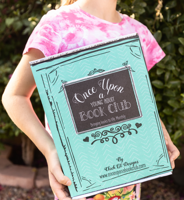 A tween girl holding a Middle-grade book box