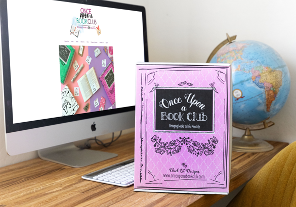 Middle-grade book boxes on a table with a PC in the background.