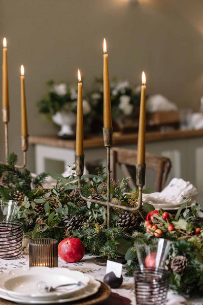 Christmas dining table with candles and greenery