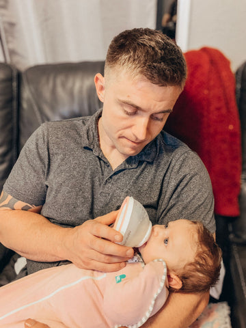 Alexandra's husband feeding Vivian with nanobébé bottle