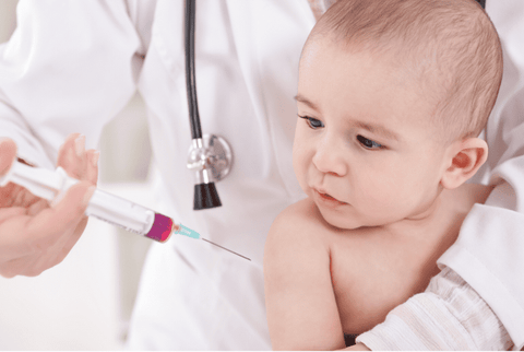 Baby getting vaccine from doctor