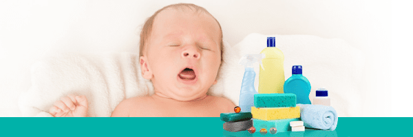 baby with sponges and cleaning products