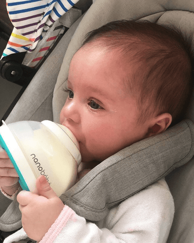 baby drinking from bottle on airplane