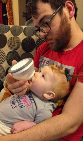 dad feeding daughter with nanobebe bottle