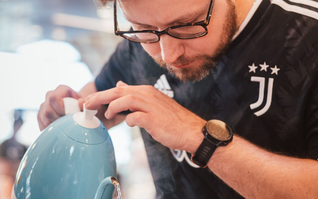 Competitor pouring with the Limited Edition Brewista Artisan Gooseneck Kettle.