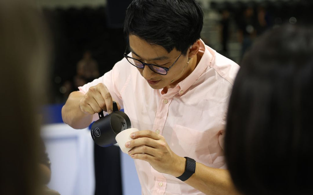 Boram Um competes in the World Barista Championships finals with a custom Brewista precision frothing pitcher.