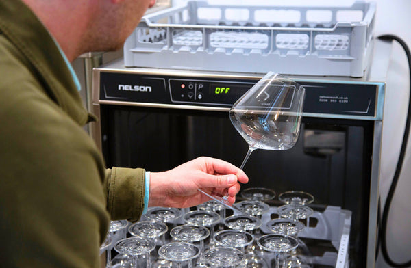 Patrick from Farr Vintners holding a wine glass that has just been washed in the Advantage AD50 glasswasher