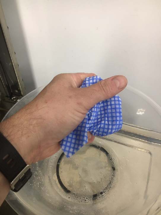 Using the cloth to remove residual water from the sump