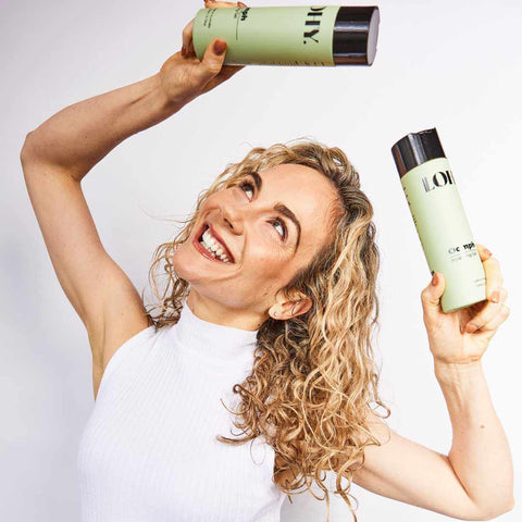 Wavy hair lady holding gel for curly hair