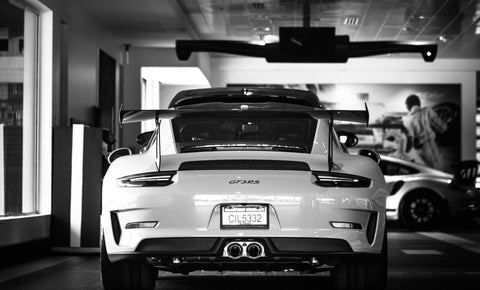 Black and white photo of a sports car in a garage