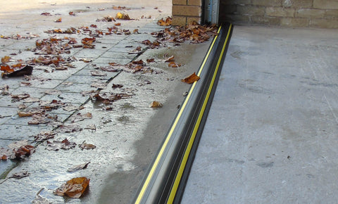 Garage door with an installed garage door floor seal