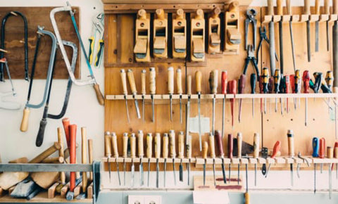 Screwdrivers and other tools stacked up on shelves