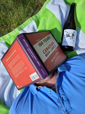 Troy sleeping with a book on his head and a beer next to him