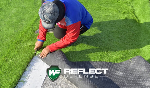 Turf installer replacing turf that melted caused by low e window glass reflection