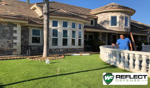 man pointing at a turf burn on artificial turf caused by window reflections