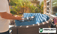 A closeup of destroyed patio furniture by nearby windows