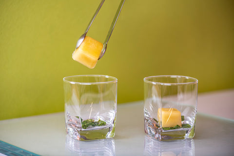 Jalapeño Citrus Mixicles Cube being placed in glass