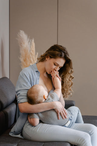 Mother Kissing Baby Before Bed