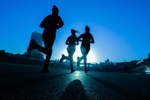 3 woman running in the morning sunrise