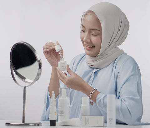 malaysian women holding a nihon skin care product