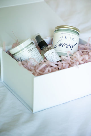 picture of a gift box featuring you are loved candle, bath salts and rose petal vegan body oil