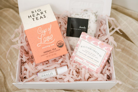 gift box with cup of love tea, bath salts, feel good potion and chocolate bar