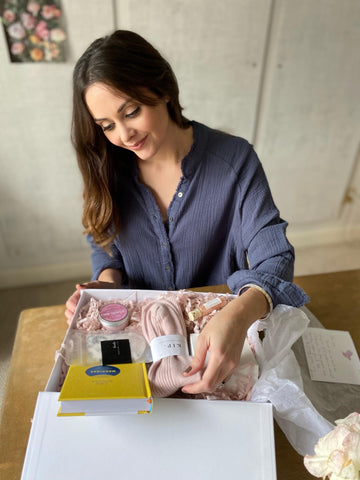 picture of a woman opening a gift box